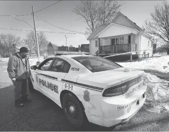  ?? DAN JANISSE ?? Todd Peretti, who lives nearby, speaks to a Windsor police officer Sunday in front of the home 3200 block of Bloomfield Road. Police are investigat­ing the suspicious death of a man in his 70s.