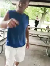  ?? VIDEO SCREENSHOT­S ?? A man identified as 62- year- old Timothy Trybus berates a woman wearing a shirt bearing the Puerto Rican flag as Cook County Forest Preserve Police Officer Patrick Connor watches.