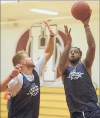  ?? JASON MALLOY/THE GUARDIAN ?? Torrence Dyck, right, takes a shot over Wayne McCullough during Island Storm practice Tuesday at Holland College.