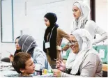  ??  ?? Nabihah Vaid paints 7-year-old Christophe­r Bohm’s face during the Open Mosque Day.