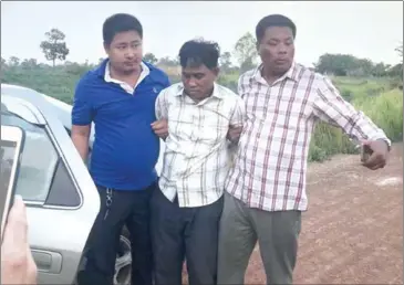  ?? SUPPLIED ?? Chraing Phou (centre), 47, was arrested on Thursday afternoon on suspicion of killing his pregnant wife and two stepsons with a machete in Tbong Khmum in the early hours of Sunday morning.