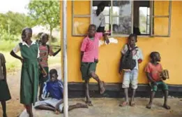  ?? — AP ?? In this photo taken on June 7, 2017, a mixture of South Sudanese refugee children and Ugandan children stand outside their classroom during break at the Ombechi Primary School in Bidi Bidi refugee settlement in northern Uganda.