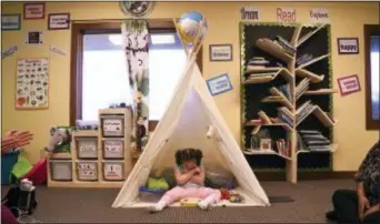  ?? AP PHOTO/THOMAS PEIPERT ?? Addelyn Patrick, 5, sits inside a teepee in the playroom at Realm of Caring in Colorado Springs, Colo. Addelyn was born with a brain malformati­on and suffers from multiple forms of seizures.