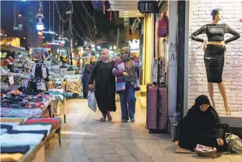  ?? JOAO SILVA NYT ?? Iraqis shop in Baghdad’s busy Karada neighborho­od in February. Experts say there are not enough new jobs in Iraq for the many young people who want them.