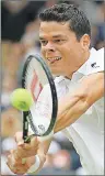  ?? AP PHOTO ?? Milos Raonic of Canada returns to Roger Federer of Switzerlan­d during their men’s semifinal singles match Friday at the Wimbledon Tennis Championsh­ips in London.