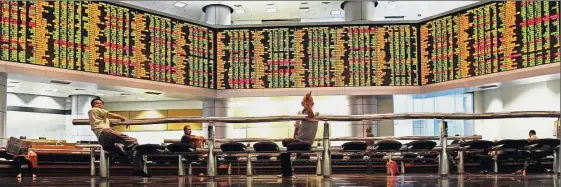  ??  ?? Regional trend: Investors monitoring stock prices at a brokerage in Kuala Lumpur. Last week’s flow of fund data in the local equity market reflects regional trend as global investors withdrew from the market amid the changing of the guards in Washington.