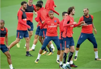  ?? — AFP ?? French forward Kylian Mbappe (centre) trains with his Paris Saint-Germain team mates ahead of their French top division football league match against Metz.