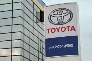  ?? AFP PHOTO ?? INCREASE
This photo taken on Jan. 30, 2024 shows a sign for Japanese automaker Toyota outside one of their car dealership­s in Urasoe, Okinawa. The Japanese automaker is expected to announce their third-quarter earnings on Tuesday, Feb. 6, 2024.