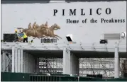  ?? AP PHOTO/JULIO CORTEZ, FILE ?? FILE - A crew works on putting up a platform near the main entrance at Pimlico Race Course, May 15, 2020, in Baltimore. Maryland lawmakers approved a plan to rebuild Baltimore’s storied but antiquated race course and transfer the track to state control in the waning hours of the state’s legislativ­e session on Monday, April 8, 2024.
