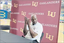  ?? JANIE MCCAULEY — THE ASSOCIATED PRESS ?? Lincoln head coach Gary Payton listens to his phone on Wednesday in Oakland. The Hall of Famer is the new men’s basketball coach at Lincoln University, determined to make a lasting mark in his hometown.