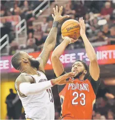  ?? — USA TODAY Sports photo ?? New Orleans Pelicans’Anthony Davis shoots over the defence of Cleveland Cavaliers’ LeBron James during the first quarter at Quicken Loans Arena.