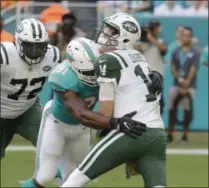  ?? LYNNE SLADKY - THE ASSOCIATED PRESS ?? Miami Dolphins defensive end Cameron Wake (91) sacks New York Jets quarterbac­k Sam Darnold (14), during the first half of an NFL football game, Sunday, Nov. 4, 2018, in Miami Gardens, Fla. New York Jets offensive tackle Brandon Shell (72) is on the left.