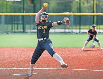  ?? PHOTOS BY JAMIE GERMANO/ROCHESTER DEMOCRAT AND CHRONICLE ?? Victor starting pitcher Olivia Steinorth winds up against Fairport.