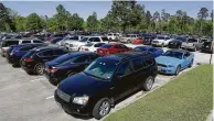  ??  ?? Commuters’ cars fill the parking lot at the Research Forest park and ride.