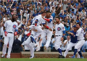  ?? Associated Press ?? ■ Chicago Cubs celebrate after Anthony Rizzo hit a game-winning home run against the Arizona Diamondbac­ks during the ninth inning of a baseball game Thursday in Chicago. The Cubs won, 7-6.