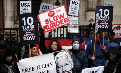  ?? ?? Supporters of Julian Assange protest outside the Royal Courts of Justice in London last month. Photograph: Henry Nicholls/Reuters