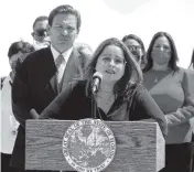  ?? CHARLES TRAINOR JR. ctrainor@miamiheral­d.com ?? Monica Zapata speaks at a press conference on Thursday announcing a lawsuit against the CDC to try to get cruising restarted at the PortMiami in Miami. Florida Gov. Ron DeSantis listens in the background.