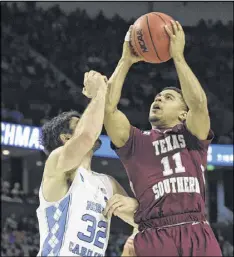  ?? RAINIER EHRHARDT / AP ?? Texas Southern’s Dulani Robinson shoots over North Carolina’s Luke Maye in the Tigers’ first-round loss to the No. 1 seed Tar Heels.