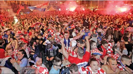  ?? — AP ?? Croatian fans celebrate their victory over England, at Zagreb in Croatia.