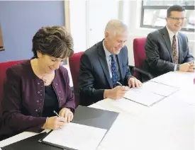  ??  ?? Camosun College president Sherri Bell signs the Education Victoria agreement with superinten­dent of School District 61 Piet Langstraat, centre, and Dave Eberwein of School District 63.