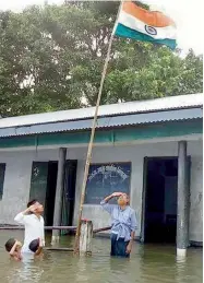  ??  ?? (left) Teachers and students of a school in flood-hit Dhubri district of Western Assam made sure the Tricolour was hoisted and the National Anthem was sung to celebrate India’s 71st Independen­ce Day.