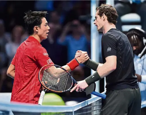  ??  ?? Good game: Britain’s Andy Murray (right) shakes hands with Japan’s Kei Nishikori after their round robin stage men’s singles match in the ATP World Tour Finals in London on Wednesday. Murray won 6-7 (9-11), 6-4, 6-4. — AFP