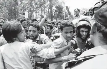  ?? Abir Abdullah
European Pressphoto Agency ?? STUDENT ACTIVISTS try to breach a police barricade in Dhaka, Bangladesh. University students held a protest in response to the slaying of Nazimuddin Samad, 27, a law student who denounced religious extremism.