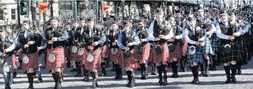  ?? PHOTOS: LINDA ROBERTSON ?? On the march . . . About 15 pipe bands march through Dunedin’s city centre during Octagonal Day at the weekend.