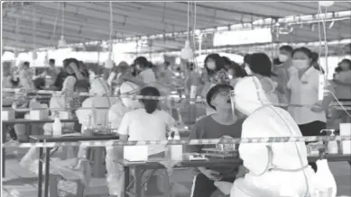  ??  ?? BEIJING
Medical workers conduct nucleic acid tests for residents following new cases of COVID-19, in Xiamen.
-AFP