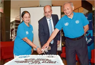  ??  ?? Wishing for global peace: (From left) Dr Jayanthi, Priesnar and Dr Chong cutting a cake to celebrate UN’s 75th anniversar­y. — RAJA FAISAL HISHAN/The Star