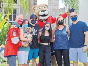  ??  ?? The Florida Panthers surprised winner John Mandile, of Boca Raton, as the winner of the Territory Teammates drive for the individual that made an impact on them. From left are John Mandile, Rori Mandile, Gizmo, Noah Mandile, Meghan Mandile, Linda Arnold and Gary Arnold.