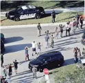  ?? MIKE STOCKER/AP ?? Students hold their hands in the air as they are evacuated by police from Marjory Stoneman Douglas High School in Parkland, Fla., after a shooter opened fire on the campus Feb. 14.