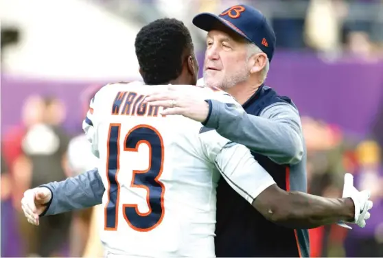  ?? | BRUCE KLUCKHOHN/ AP ?? Bears coach John Fox hugs wide receiver KendallWri­ght before the season finale against the Minnesota Vikings on Sunday at U. S. Bank Stadium.