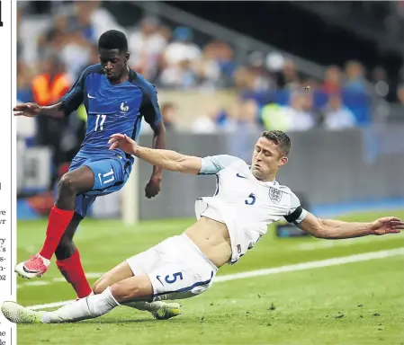  ?? /JULIAN FINNEY/GETTY IMAGES ?? Ousmane Dembele of France is tackled by Gary Cahill of England in an internatio­nal friendly in Paris last year. Cahill is ready to take on a lead role at the World Cup in Russia.