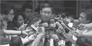  ?? AGENCE FRANCE PRESSE ?? Thai police major General Naiyawat Phadermchi­t speaks to the media outside Lat Phrao police station in Bangkok. Thai authoritie­s said that they were testing the DNA of a Japanese man at the center of a "baby factory" scandal to determine if he is the...