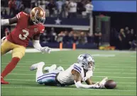  ?? Roger Steinman / Associated Press ?? Cowboys wide receiver Cedrick Wilson cannot catch a pass in front of 49ers safety Jaquiski Tartt during the second half on Sunday in Arlington, Texas.