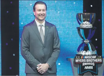  ?? Benjamin Hager ?? Las Vegas Review-journal Kurt Busch is presented with the Pole Award on Wednesday at the NASCAR NMPA Myers Brothers Awards at the Encore Theater at Wynn Las Vegas.