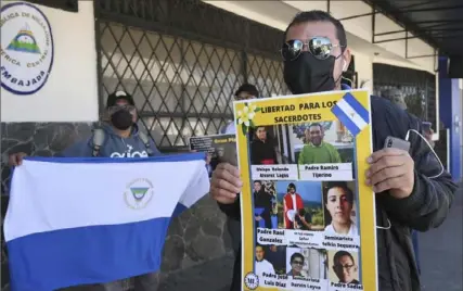  ?? Carlos Gonzalez/Associated Press ?? A Western Democratic Movement activist holds a poster with a message that reads in Spanish; “Free the priests,” and images of clergy imprisoned by the government of Daniel Ortega, including Bishop Rolando Álvarez of Matagalpa. The activist was at a protest outside the Nicaraguan embassy, in San Jose, Costa Rica, Feb. 20.