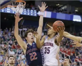 ?? RICK BOWMER — THE ASSOCIATED PRESS ?? Arizona guard Allonzo Trier tries to shoot over Saint Mary’s Dane Pineau (22) and Evan Fitzner, right, during the first half in Salt Lake City on Saturday.