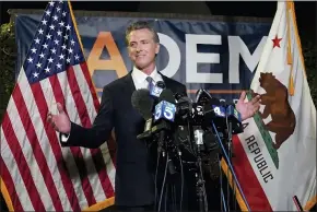  ?? AP PHOTO/RICH PEDRONCELL­I ?? California Gov. Gavin Newsom addresses reporters after beating back the recall attempt that aimed to remove him from office, at the John L. Burton California Democratic Party headquarte­rs in Sacramento, Calif., Tuesday, Sept. 14, 2021.