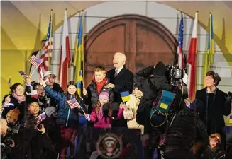  ?? Alastair Grant/Associated Press ?? President Joe Biden poses with children after meeting with Polish President Andrzej Duda in Warsaw, Poland, Tuesday.