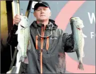  ?? NWA Democrat-Gazette/FLIP PUTTHOFF ?? Johnny McCombs of Morris, Ala., caught five bass weighing 18 pounds, 15 ounces Saturday and jumped from 11th place to first in the FLW Tour event on Beaver Lake.