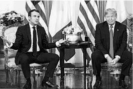  ?? EVAN VUCCI/AP ?? President Donald Trump listens as French President Emmanuel Macron speaks during a meeting Tuesday at Winfield House during the NATO summit in London.