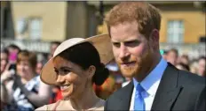  ??  ?? Meghan, the Duchess of Sussex walks with her husband, Prince Harry as they attend a garden party at Buckingham Palace in London. DoMInIc lIPInskI/Pool PhoTo VIA AP