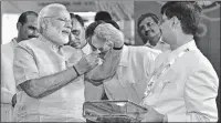  ??  ?? Prime Minister Narendra Modi inspects a thread sample during 'Textile India 2017'- a four-day mega fair at Mahatma Mandir in Gandhinaga­r, Gujarat on Friday. -PTI