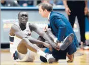  ?? BRAD HORRIGAN/HARTFORD COURANT ?? Akok Akok ruptured his Achilles during UConn’s victory over Memphis.