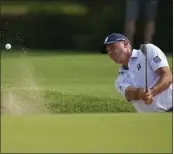  ?? SUE OGROCKI — THE ASSOCIATED PRESS ?? Matt Kuchar hits from the bunker on the seventh hole during the first round of the PGA Championsh­ip on Thursday in Tulsa, Okla.