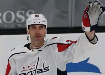  ?? NAncy lAnE pHoToS / HErAld STAFF ?? BIG Z BACK IN THE BUILDING: Zdeno Chara waves to the crowd after being honored with a video tribune during the first period. Below, Lars Eller pops in a shot behind Dan Vladar to give the Capitals a 2-0 lead.