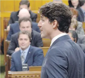  ?? — THE CANADIAN PRESS ?? Prime Minister Justin Trudeau responds during question period in the House of Commons on Monday, as Conservati­ve leader Andrew Scheer, left, looks on.