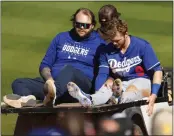  ?? K.C. ALFRED — THE SAN DIEGO UNION-TRIBUNE ?? The Dodgers’ Gavin Lux is carted off the field after getting injured running to third base against the Padres during a spring training game on Monday in Peoria, Arizona.